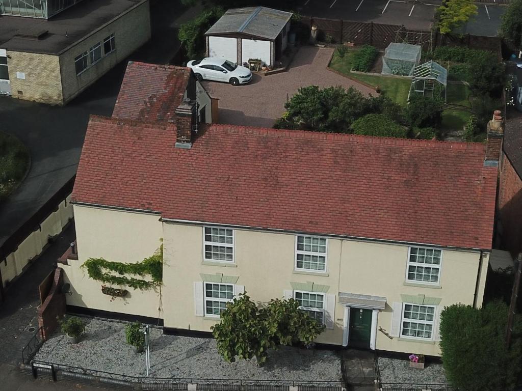 an overhead view of a white house with a red roof at Woodlands 159 in Pershore