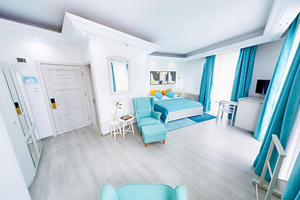 a living room with a blue couch and a table at Relax Comfort Suites Hotel in Bucharest