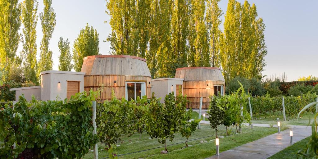 a house with two domes in a garden with trees at Villa Mansa in Vistalba