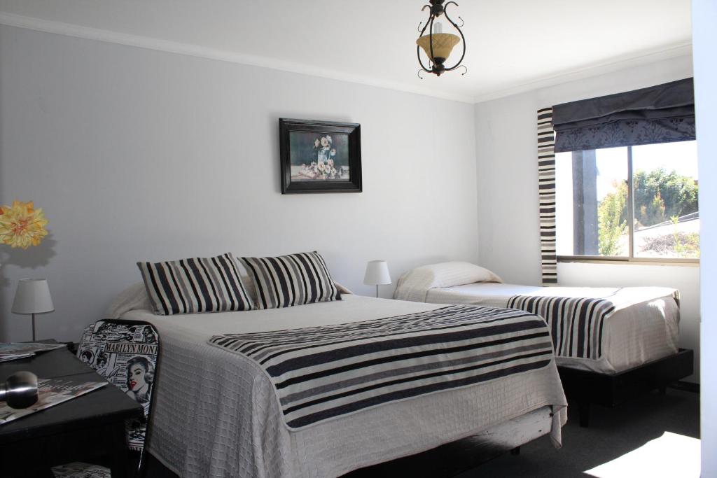 Postel nebo postele na pokoji v ubytování Hotel Maquehue