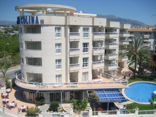 a large hotel with a swimming pool in front of it at La Colina in Albir