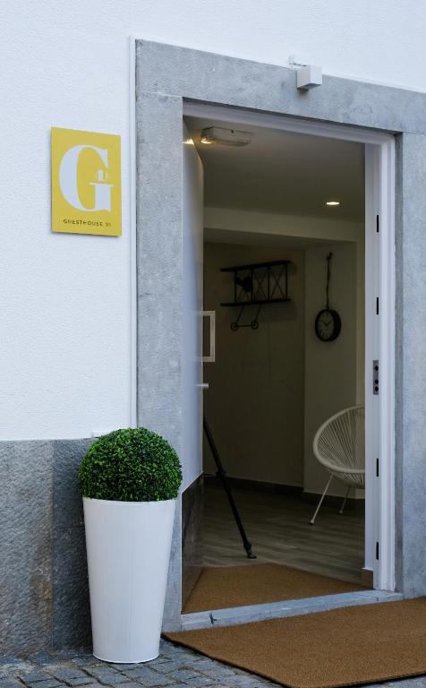 a entrance to a building with a plant in the doorway at 4U Lisbon VI Guesthouse Airport in Lisbon