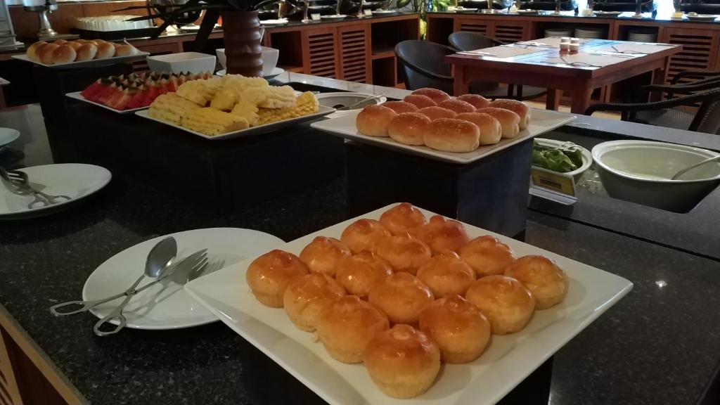 a buffet with plates of food on a counter at Supalai Scenic Bay Resort And Spa, SHA Extra Plus in Por Bay