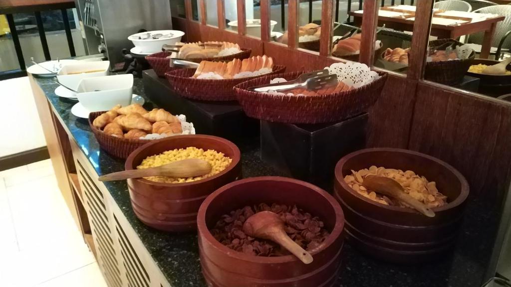 a buffet with bowls of food on a counter at Supalai Scenic Bay Resort And Spa, SHA Extra Plus in Por Bay