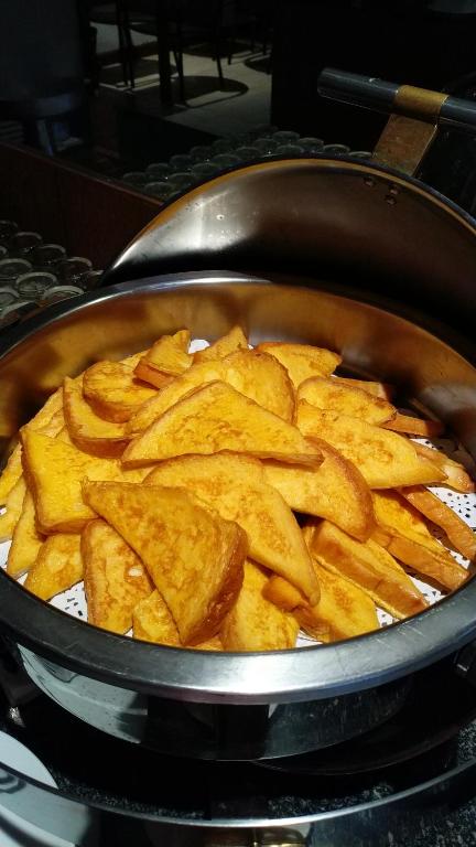 a pan filled with potato chips sitting on a stove at Supalai Scenic Bay Resort And Spa, SHA Extra Plus in Por Bay