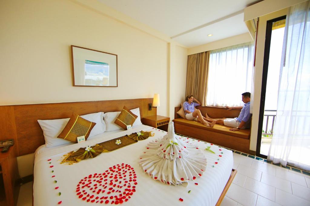 a hotel room with a bed with a heart decoration on it at Supalai Scenic Bay Resort And Spa, SHA Extra Plus in Por Bay