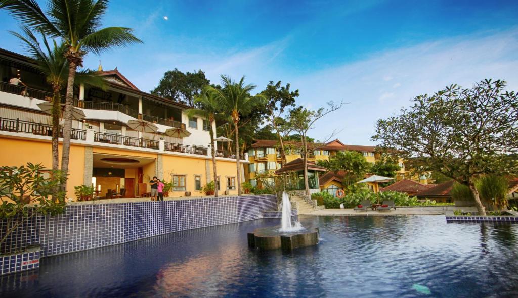 a fountain in a pool in front of a building at Supalai Scenic Bay Resort And Spa, SHA Extra Plus in Por Bay