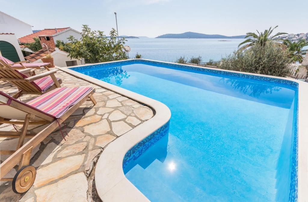 a swimming pool with a view of the water at Villa Gajeta in Sevid