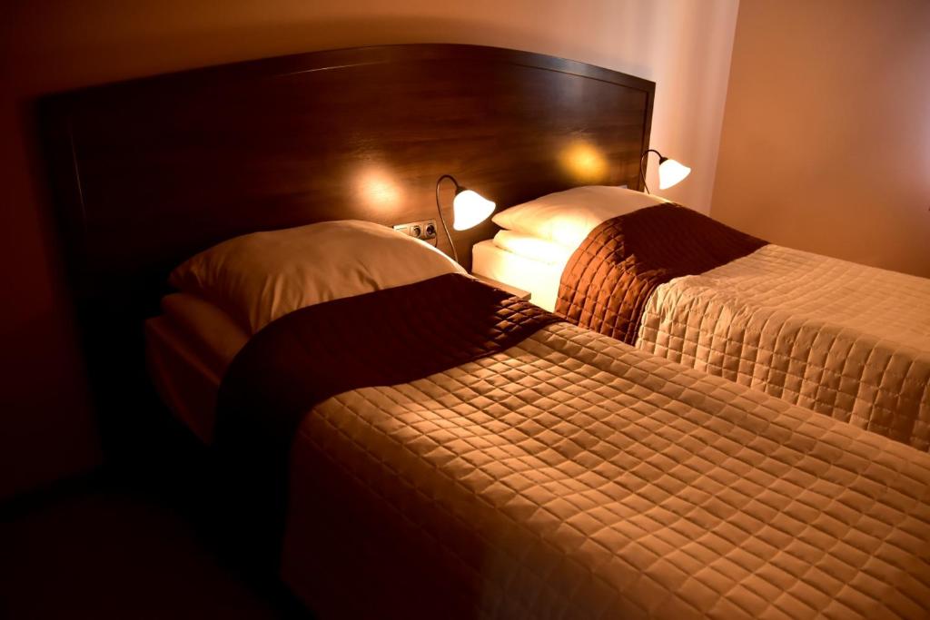 Postel nebo postele na pokoji v ubytování Hotel Nekla