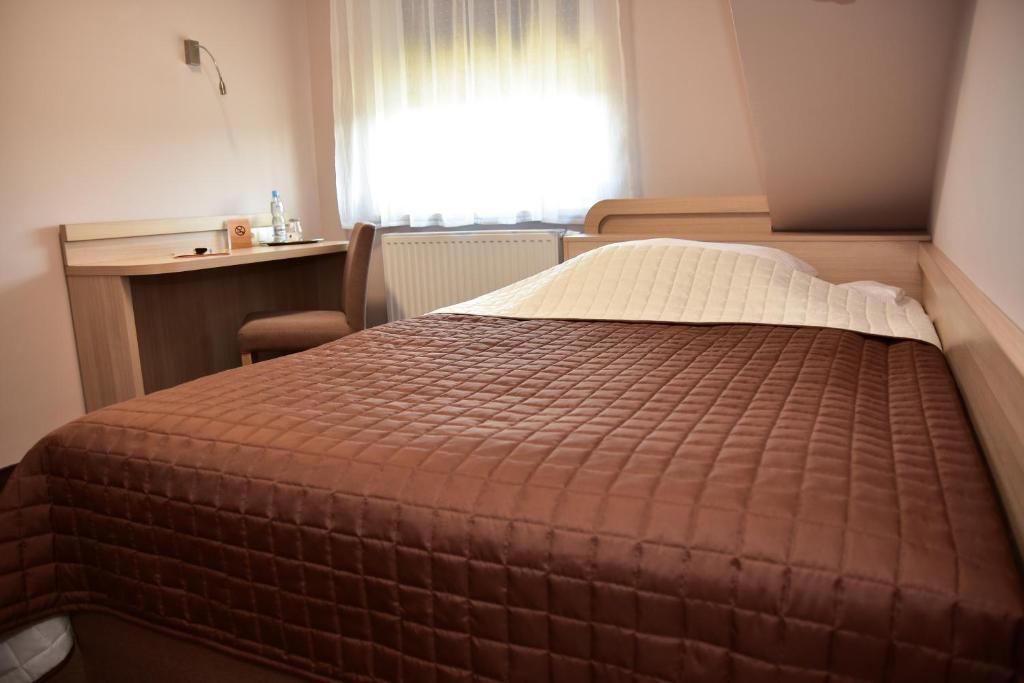 Postel nebo postele na pokoji v ubytování Hotel Nekla