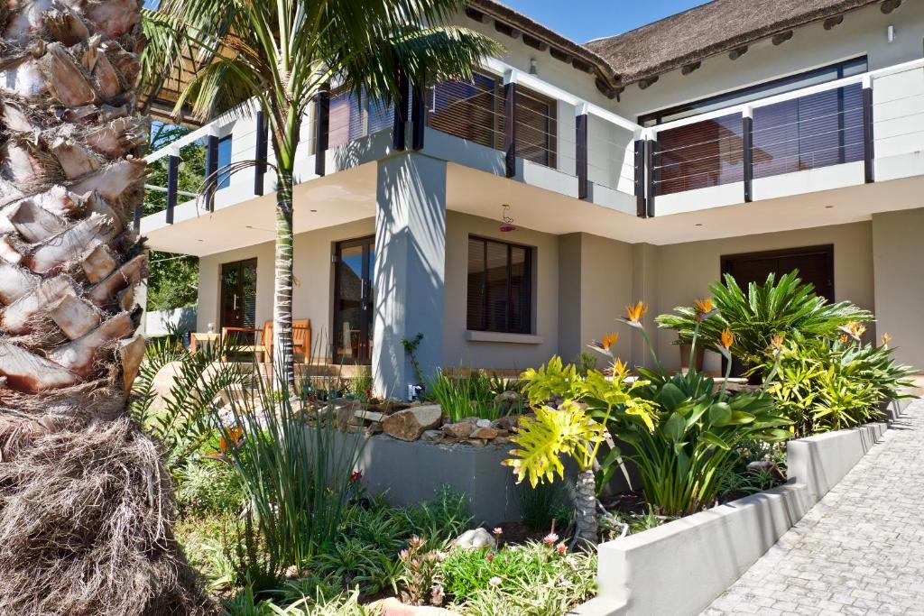 a house with a garden in front of it at Normarie's Guesthouse in Wilderness