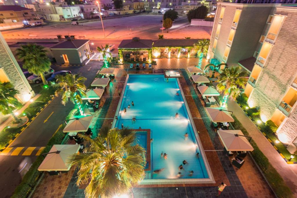 an overhead view of a swimming pool at night at Boudl Gardenia Resort in Al Khobar