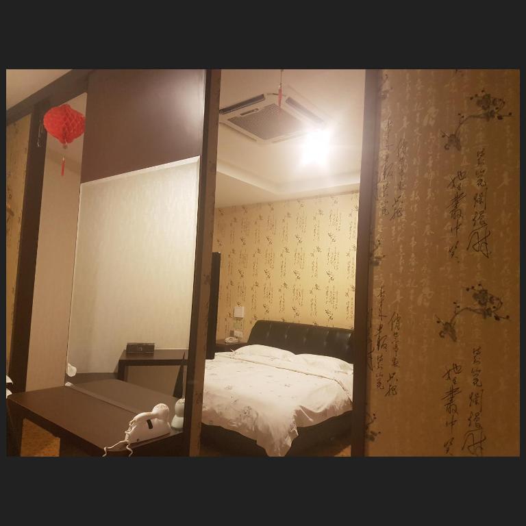 Postel nebo postele na pokoji v ubytování Hotel Tebrau CT