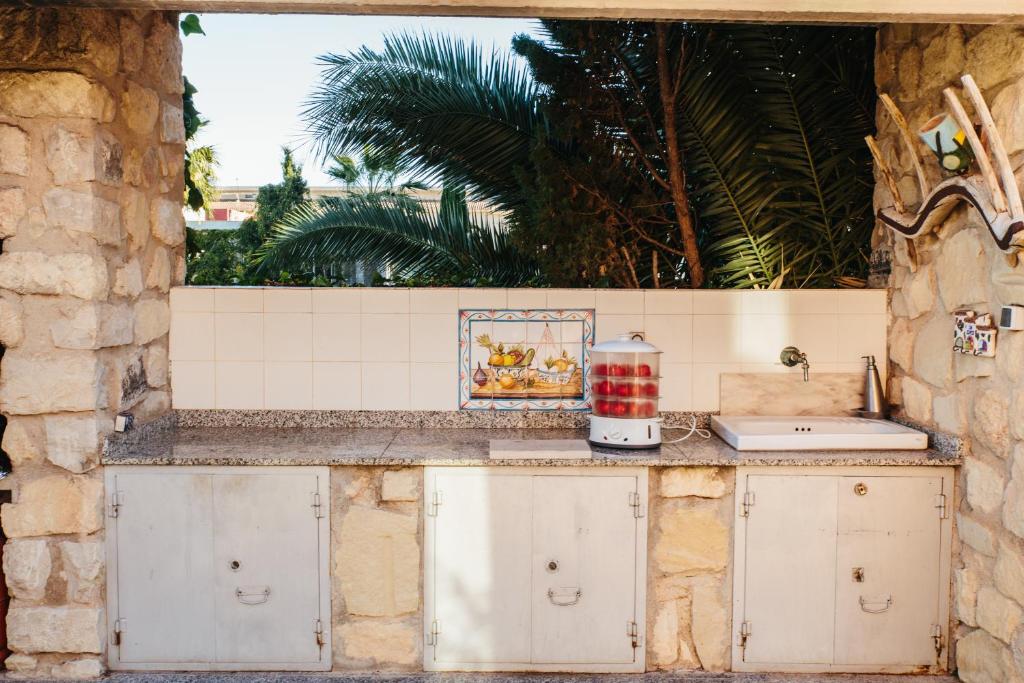 a kitchen with white cabinets and a counter top at Mi Refugio in Alicante