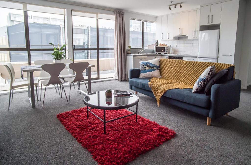 a living room with a couch and a table at U Residence Hotel in Wellington