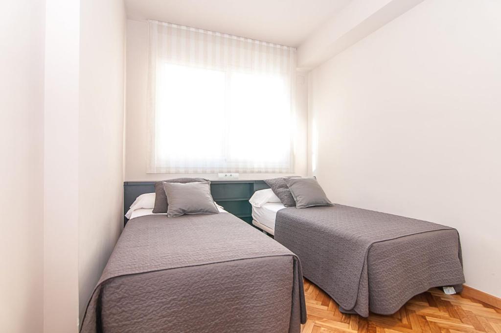A bed or beds in a room at Weflating Diagonal
