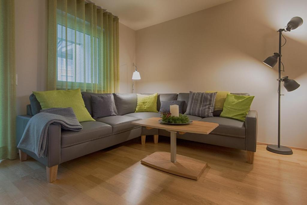 上斯陶芬的住宿－FeWo "Staufen Lodge" Oberstaufen，客厅配有沙发和桌子