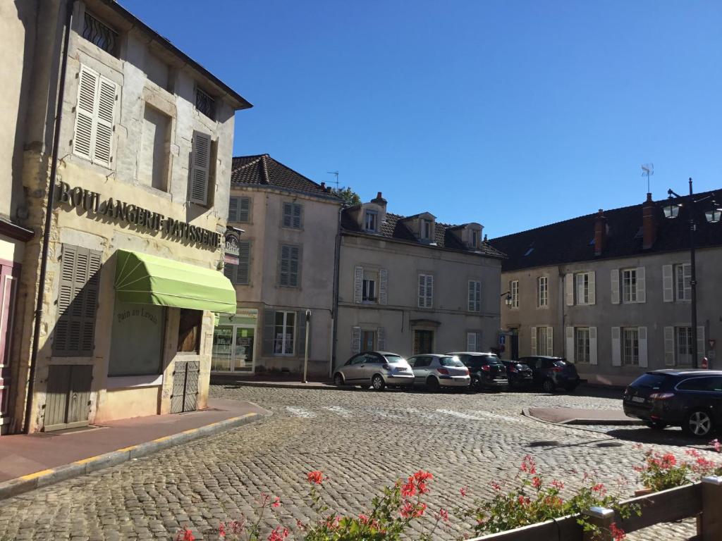 a cobblestone street in a town with buildings at Aux Cornettes in Beaune