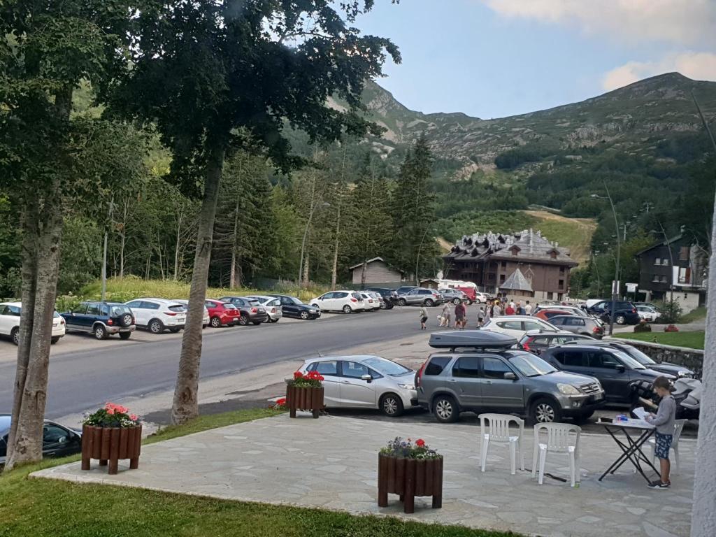 a parking lot with cars parked on the side of a road at Val di Luce-Foemina 78 in Abetone