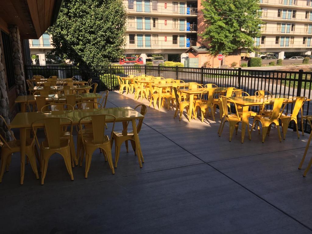 a row of yellow tables and chairs on a patio at Creekstone Inn in Pigeon Forge