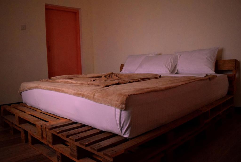 A bed or beds in a room at Laughing Leopard Hostel