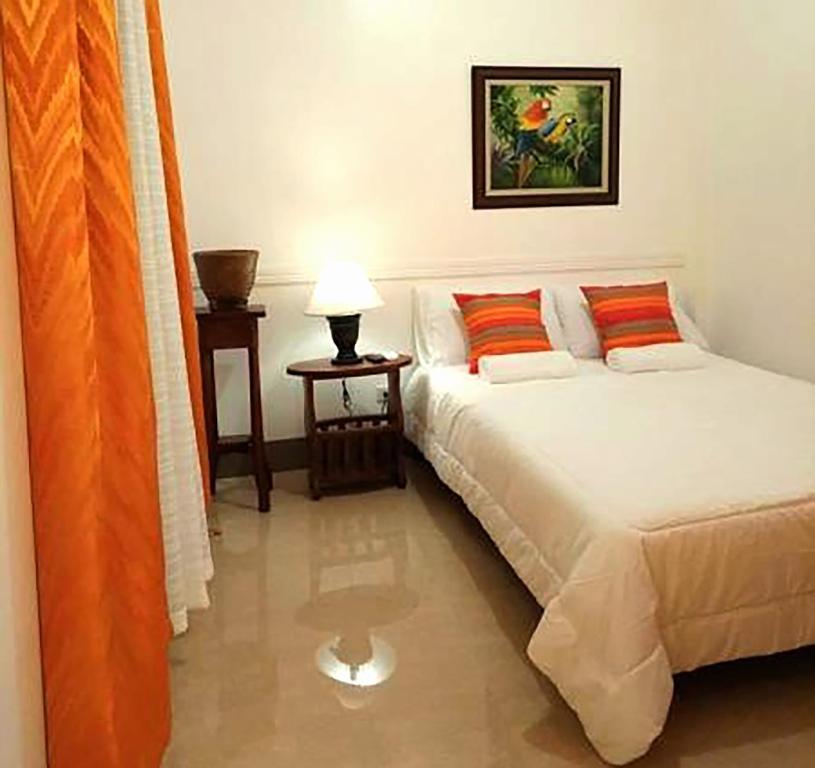 a bedroom with two beds and a lamp in it at Prosperity Inn in Vigan