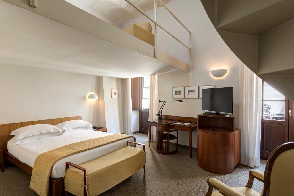 Postel nebo postele na pokoji v ubytování Hotel Tiferno