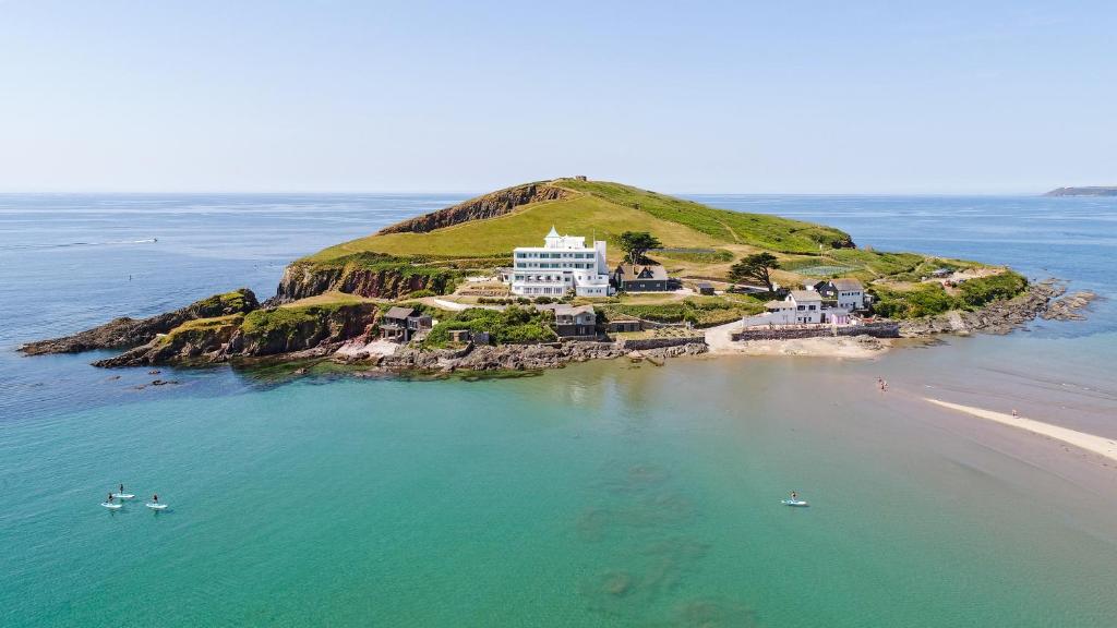 
a large body of water with a lighthouse at Burgh Island Hotel in Bigbury on Sea
