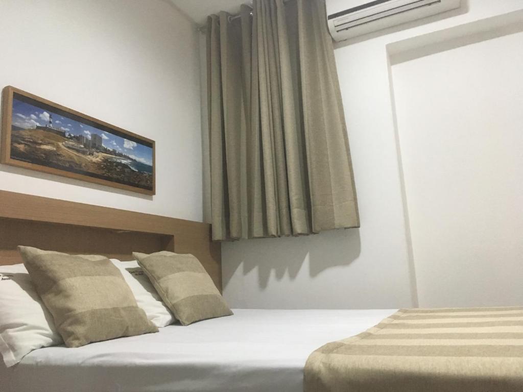 Postel nebo postele na pokoji v ubytování Hotel Dom Passos