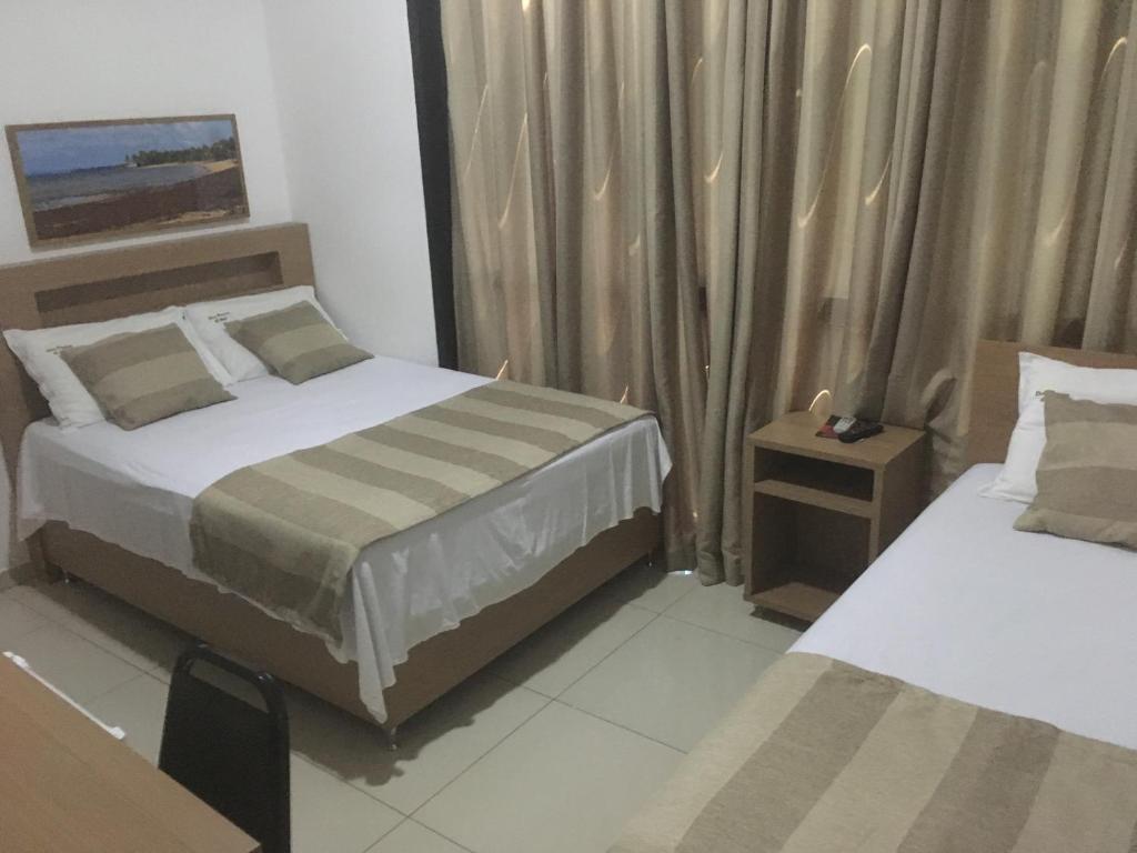 Postel nebo postele na pokoji v ubytování Hotel Dom Passos