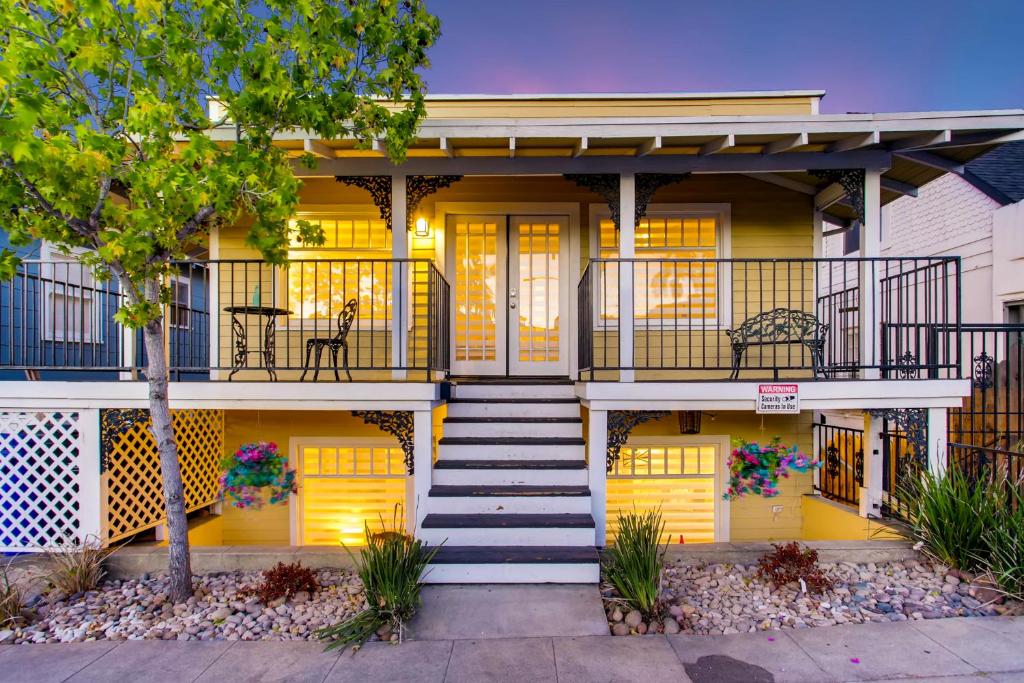 a yellow house with yellow doors and stairs at Casa California in San Diego