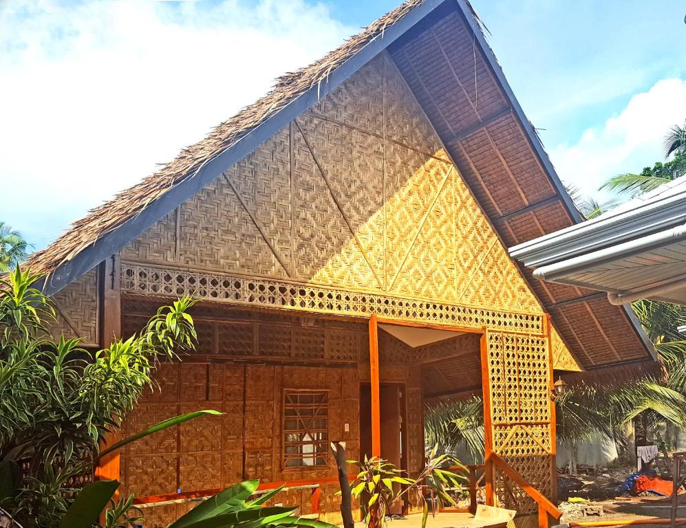 a house with a thatched roof at MJ Room Rental in Panglao Island