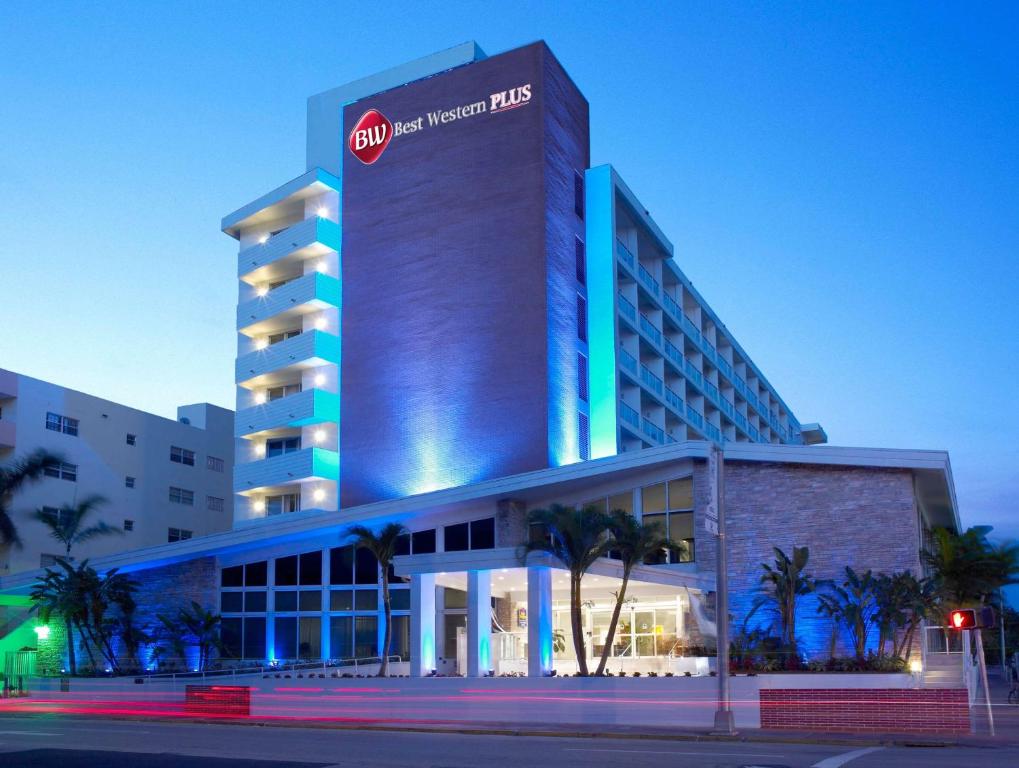 
a large building with a clock on the front of it at Best Western Plus Atlantic Beach Resort in Miami Beach
