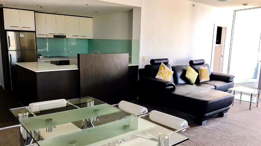 ein Wohnzimmer mit einer Couch und einem Tisch in der Unterkunft Oaks Townsville Gateway Suites in Townsville