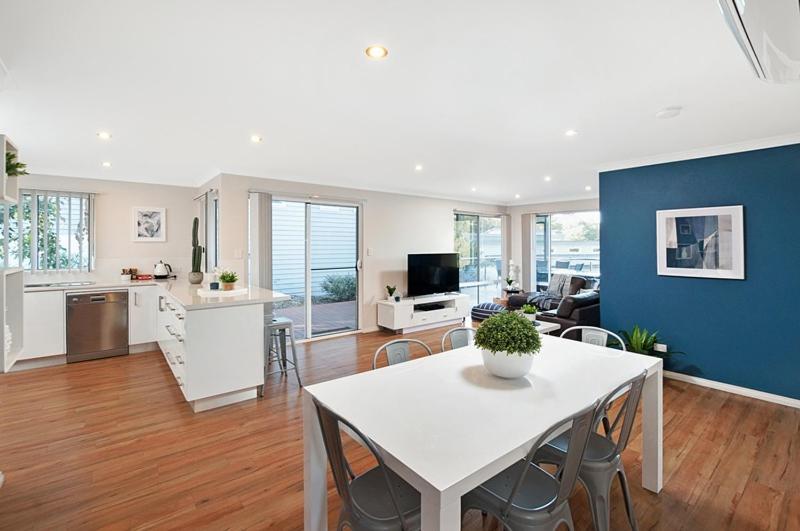 a kitchen and living room with a white table and chairs at Forest View Villa in Dunsborough