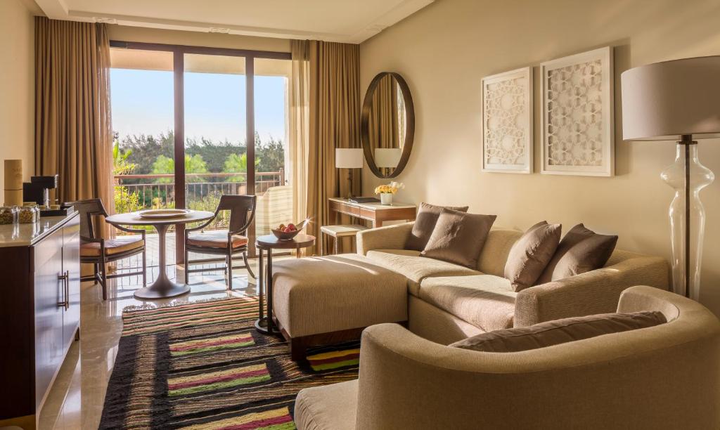 a living room with a couch and a table at Four Seasons Hotel Tunis in Gammarth