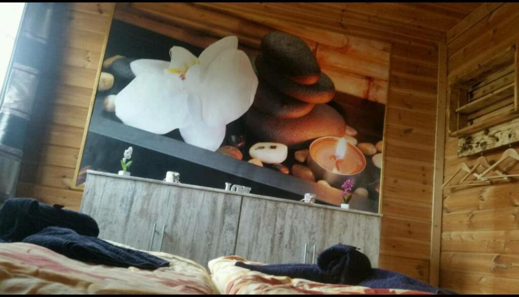 a bedroom with a bed and a shelf with mushrooms at Ferienwohnung“puutalossa“ in Sehlen