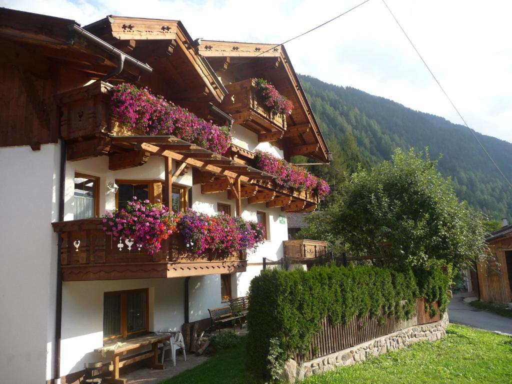 a building with flowers on the balconies of it at Familie Neunhäuserer in Neustift im Stubaital