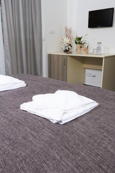 two white towels on a bed in a room at APARTMÁNY RYBNÍČEK in Staré Město