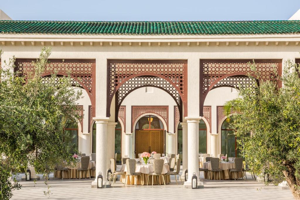 a courtyard of a building with tables and chairs at Four Seasons Hotel Tunis in Gammarth