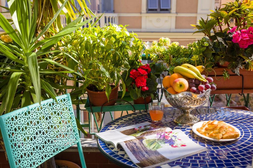 a table with a bowl of fruit and a plate of food at Diamond Apartment in Genova
