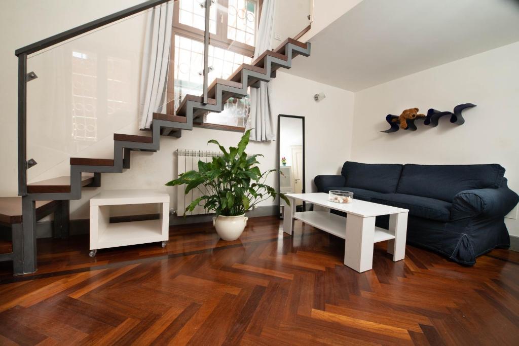 uma sala de estar com um sofá e uma escada em Suite Rodinò em Nápoles
