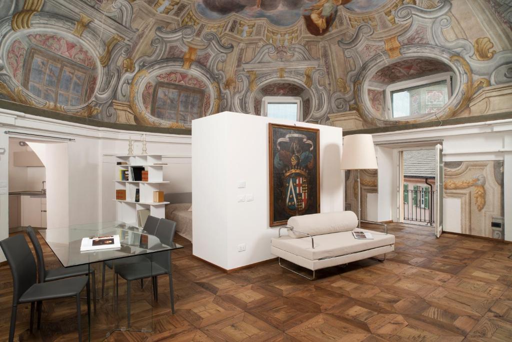 a living room with a coffered ceiling and a table at Cupola Rubatti Tornaforte: Apollo e le sue Muse in Cuneo