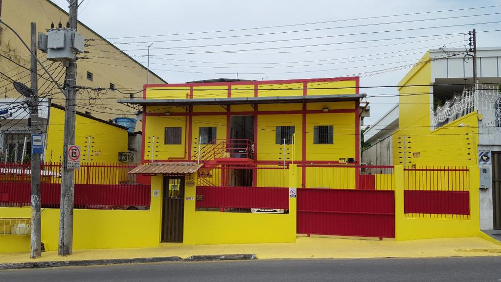 a yellow and red building on the side of a street at VilaVerin Apartments in Manaus