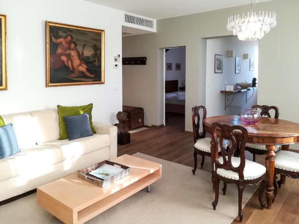 a living room with a white couch and a table at Appartamento Rio de la Fornace in Venice