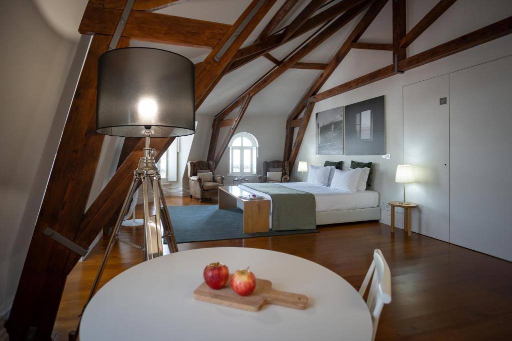 a bedroom with a bed and a table with apples on it at AC-Armazéns Cogumbreiro in Ponta Delgada