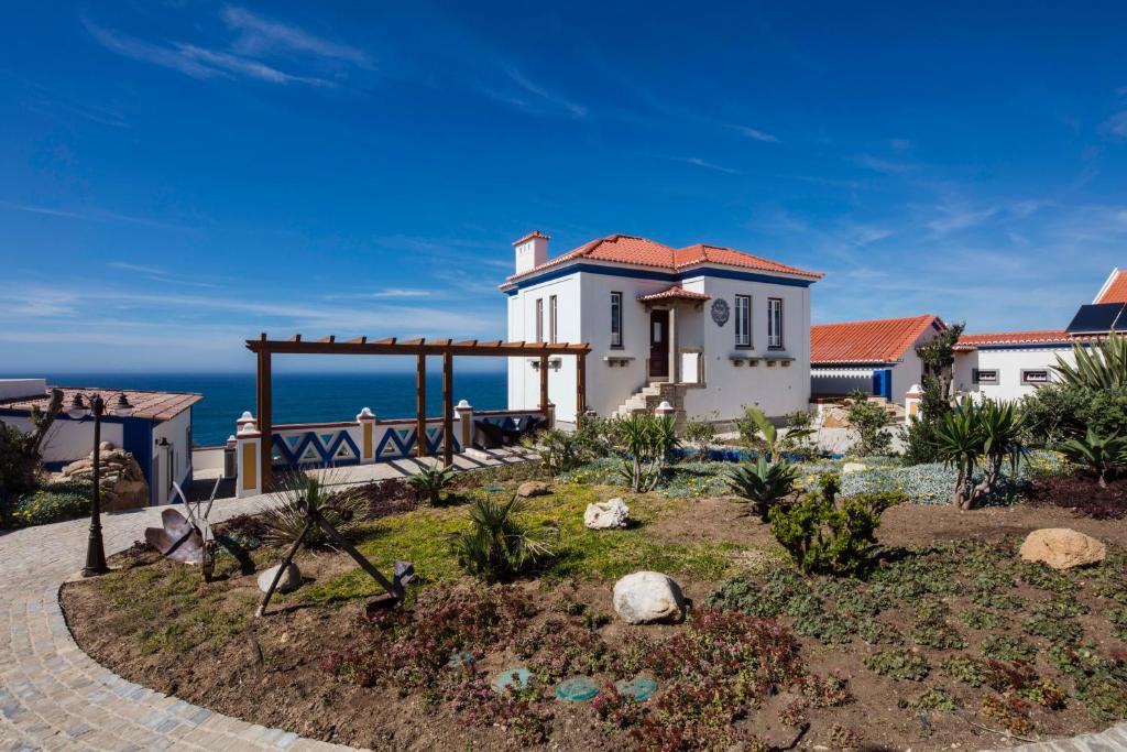 a house with a view of the ocean at Chalet O Amorzinho Sintra Praia in Sintra