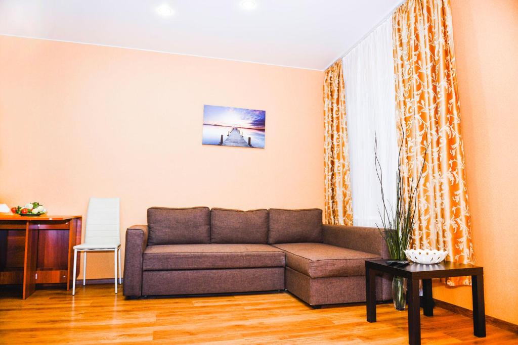 a living room with a couch and a table at W Apartaments Krepostnaya 12/2 in Vyborg