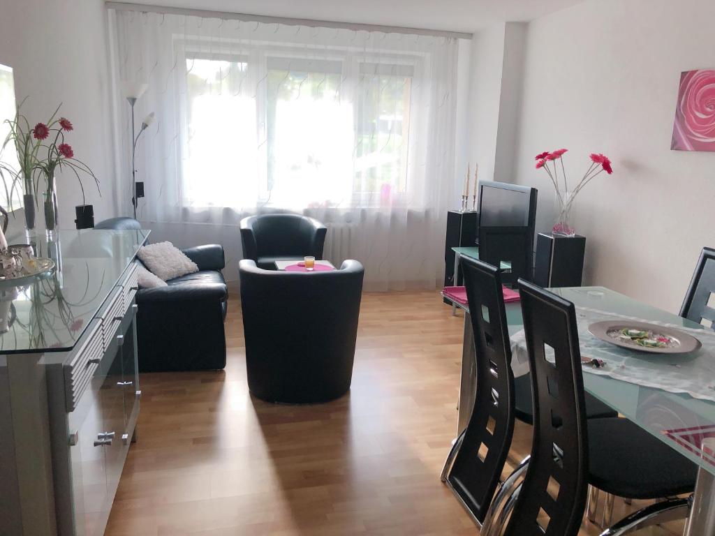 a living room with a couch and a table and chairs at Apartament Familia in Ustrzyki Dolne