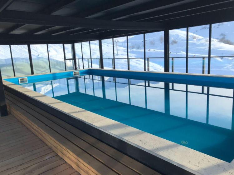 an empty swimming pool on a building with water at Gudauri loft -Apartment in Gudauri